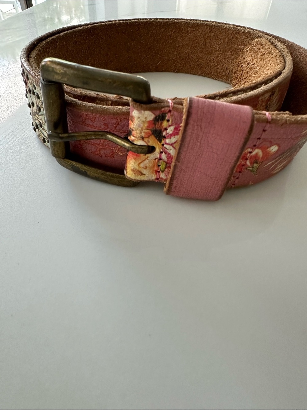 pink leather belt featuring the signature Ed Hardy logo script and floral tatto